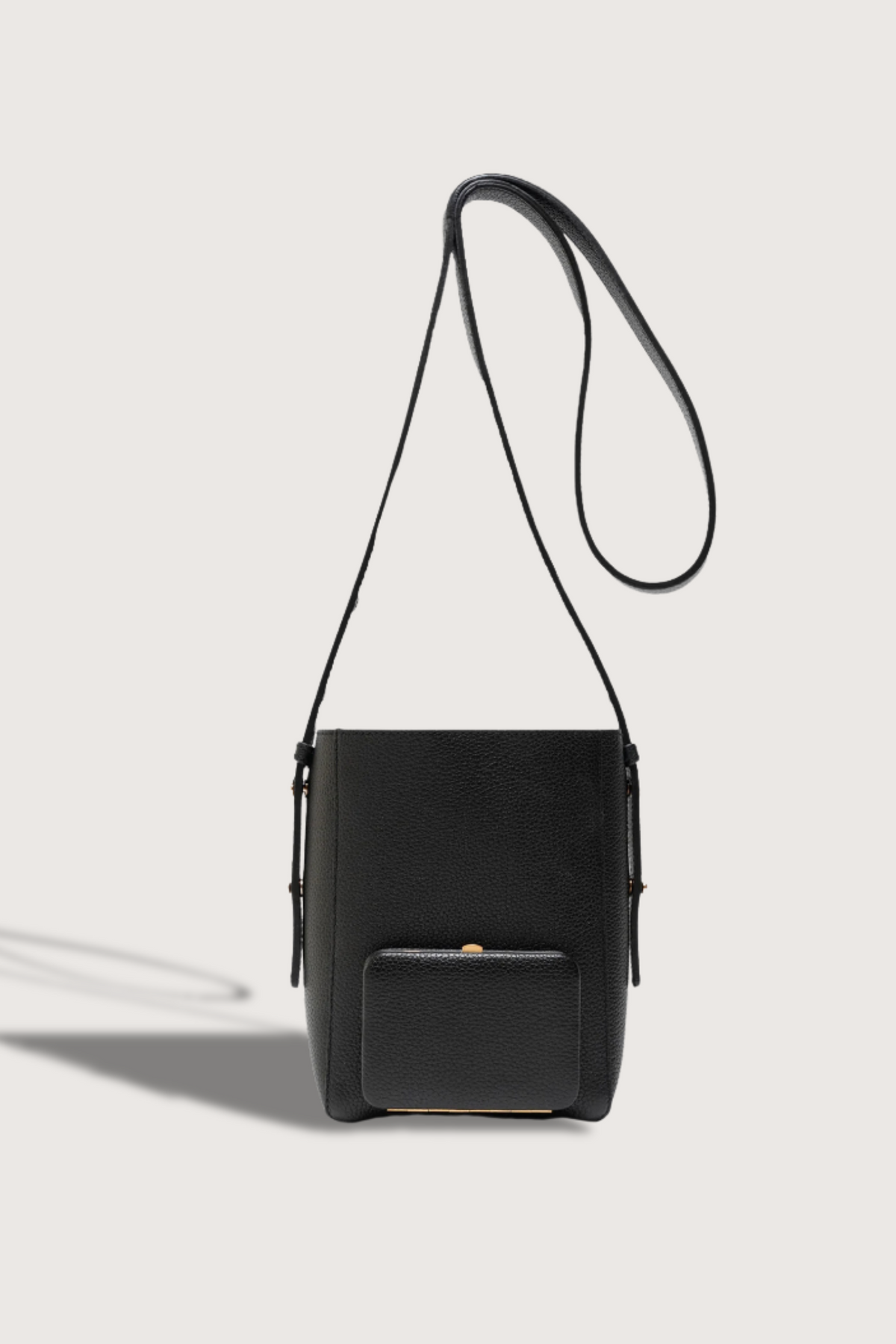 flat lay Parker S Soft Black leather Crossbody Bag with adjustable strap and exterior pocket