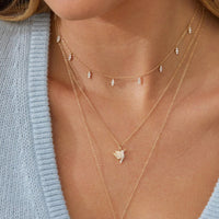 model wearing Pave Diamond Mini Hummingbird Necklace 14k gold
