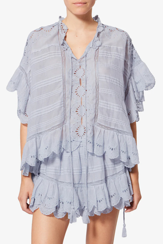 front profile model wearing Payton Top Light Blue Caftan style organic cotton and floral lace top
Round collar with tie strings
Broderie anglaise and pintucks
Short frilly sleeves
Side frills and drawstrings
Flared cut
100% cotton