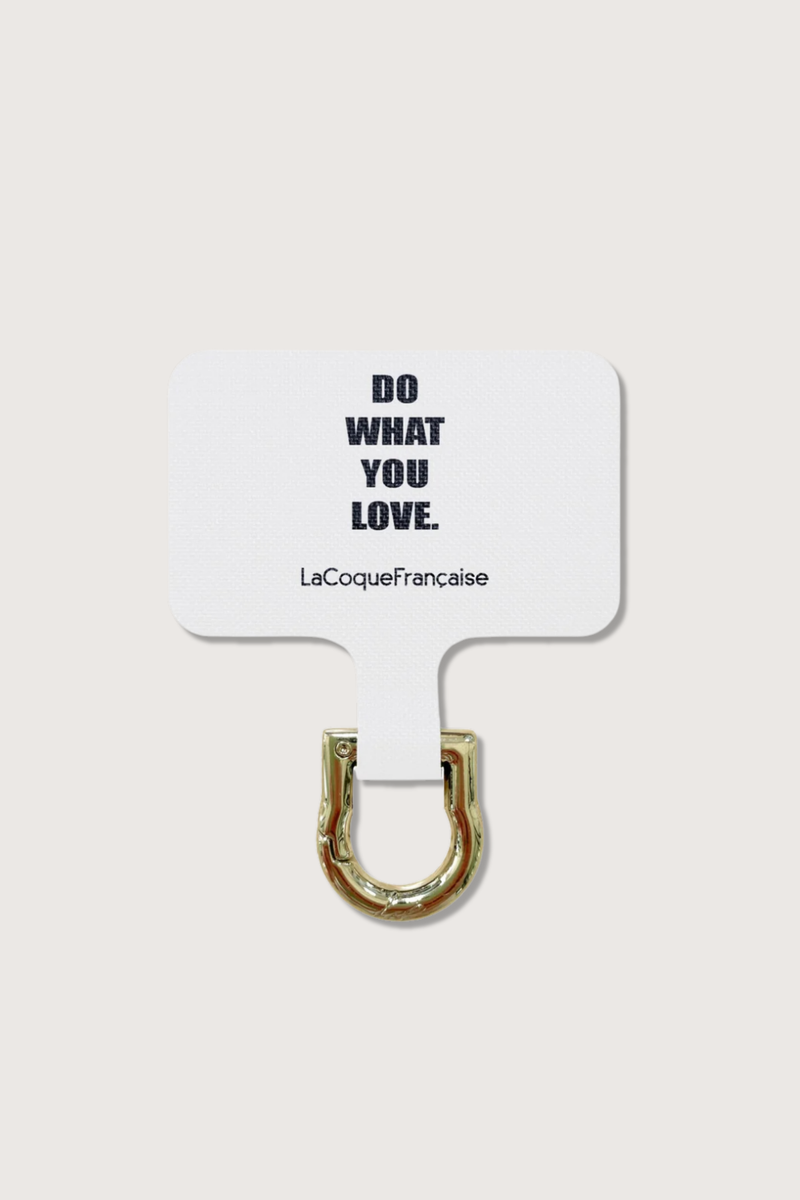 flat lay Personalized Adapter - Do What You Love white Universal adapter
"Do What you love Design" text with La Coque Francaise branding below
Easily attach your chain to any phone, while keeping your current case
Fits discreetly into your existing case
A removable carabiner protrudes slightly from the charging connector, making it easy to attach your chain
Made of white fabric with a gold coating&nbsp;