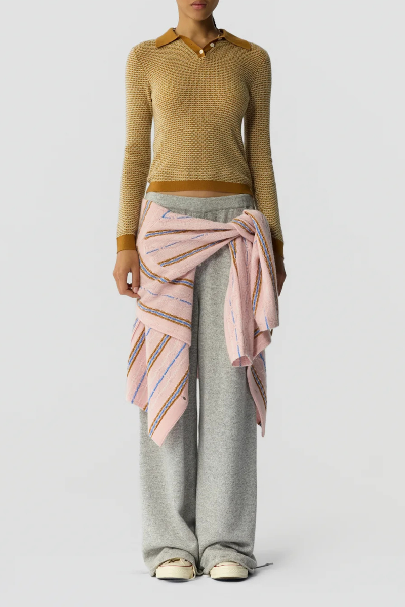 front profile model wearing  Pique Shrunken Long Sleeve Polo Cashmere suede caramel FINE WEIGHT LS PIQUE STITCH POLO
RIB POLO COLLAR
THREE BUTTON HALF PLACKET CLOSURE
RIB HEM AND CUFF TRIM
FINE TWO COLOR TEXTURE PIQUE STITCH
GIR BRANDING AT BACK NECK