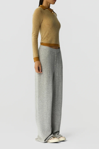 side profile model wearing  Pique Shrunken Long Sleeve Polo Cashmere suede caramel FINE WEIGHT LS PIQUE STITCH POLO
RIB POLO COLLAR
THREE BUTTON HALF PLACKET CLOSURE
RIB HEM AND CUFF TRIM
FINE TWO COLOR TEXTURE PIQUE STITCH
GIR BRANDING AT BACK NECK