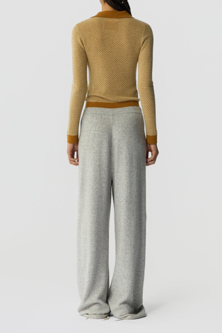 back profile model wearing  Pique Shrunken Long Sleeve Polo Cashmere suede caramel FINE WEIGHT LS PIQUE STITCH POLO
RIB POLO COLLAR
THREE BUTTON HALF PLACKET CLOSURE
RIB HEM AND CUFF TRIM
FINE TWO COLOR TEXTURE PIQUE STITCH
GIR BRANDING AT BACK NECK