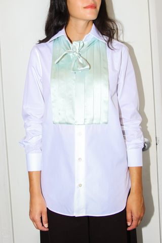 front profile model wearing Pleated Smoking Shirt With Tie White/Sage cotton white with green silk front pleat and bow detail