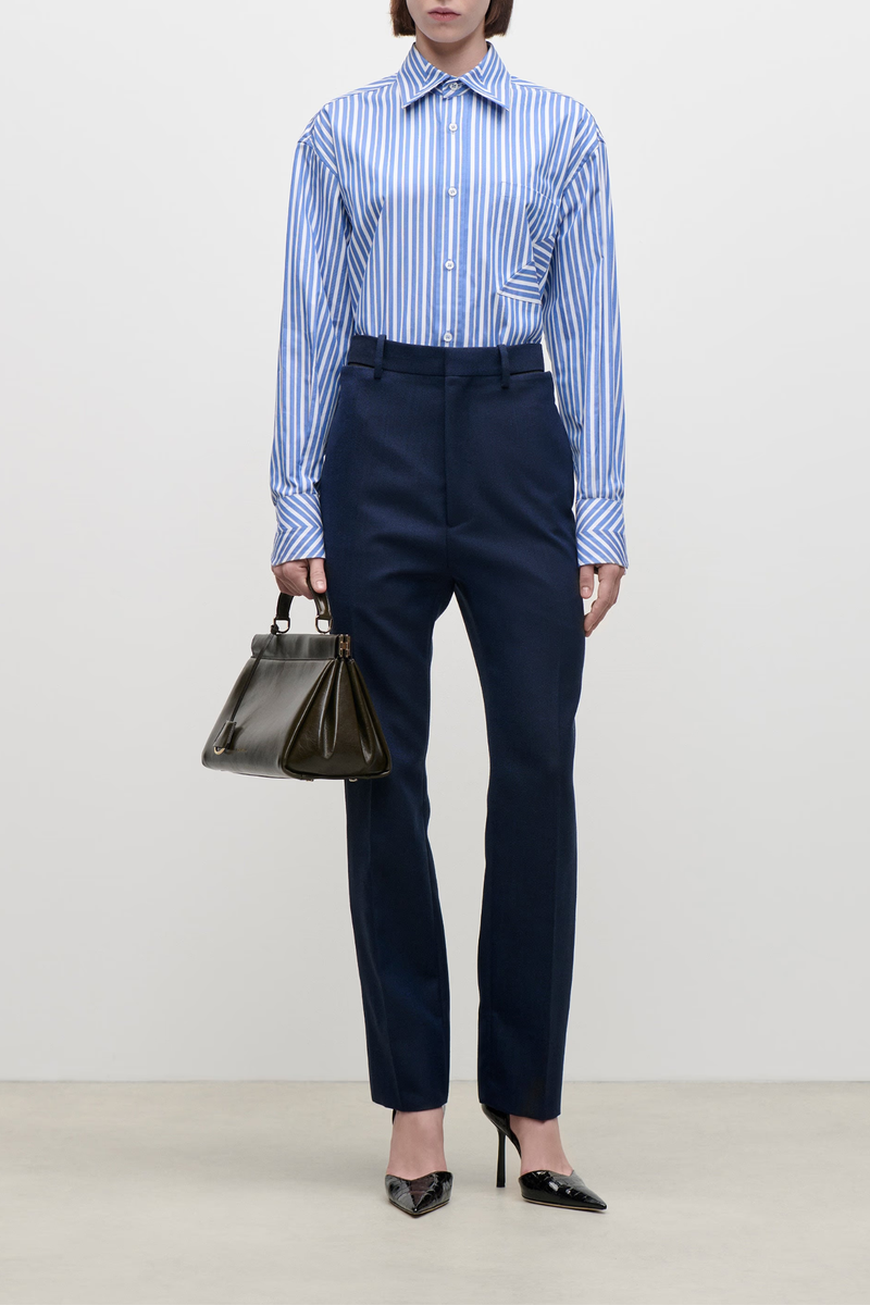 front profile model wearing  Pocket Detail Cotton Stripe Shirt blue white Striped cotton shirt
Classic shirt construction
Chest pocket detail
Seam diagonal stripe detail
100% Cotton