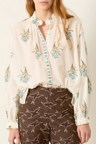 front profile model wearing Poet Sky Mist Flower Blouse off white cotton Loose fit
Ruffled collar
Dramatically gathered sleeves
Slightly sheer
Hand-block-printed with signature falling floral motif
Border-print placket
Block-printed by hand