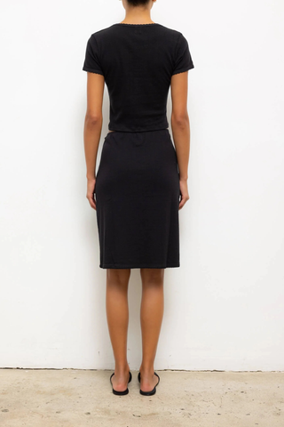 back profile model wearing  Pointelle Baby Tee Black slim fit tee
Cropped length
Cap-style sleeve
Classic crew neckline
Signature pinhole stripes
Delicate eyelets
Scalloped edging
100% Cotton