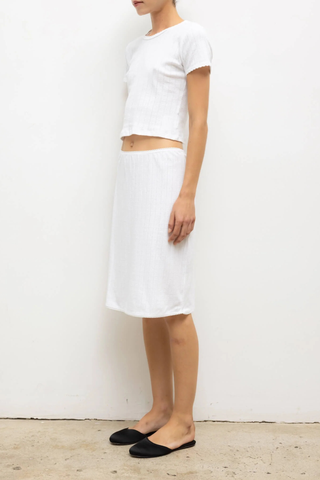 side profile model wearing Pointelle Baby Tee White slim fit
Cropped length
Cap-style sleeve
Classic crew neckline
Signature pinhole stripes
Delicate eyelets
Scalloped edging
100% Cotton