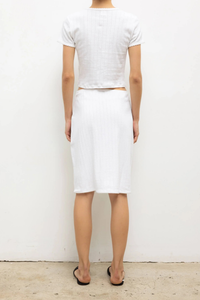 back profile model wearing Pointelle Baby Tee White slim fit
Cropped length
Cap-style sleeve
Classic crew neckline
Signature pinhole stripes
Delicate eyelets
Scalloped edging
100% Cotton