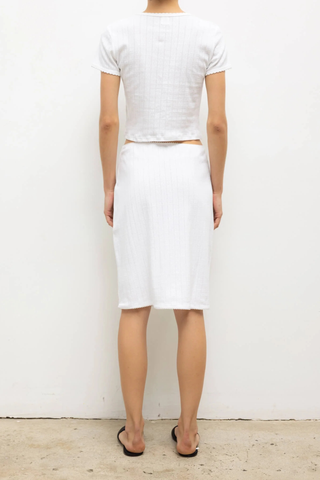 back profile model wearing Pointelle Baby Tee White slim fit
Cropped length
Cap-style sleeve
Classic crew neckline
Signature pinhole stripes
Delicate eyelets
Scalloped edging
100% Cotton