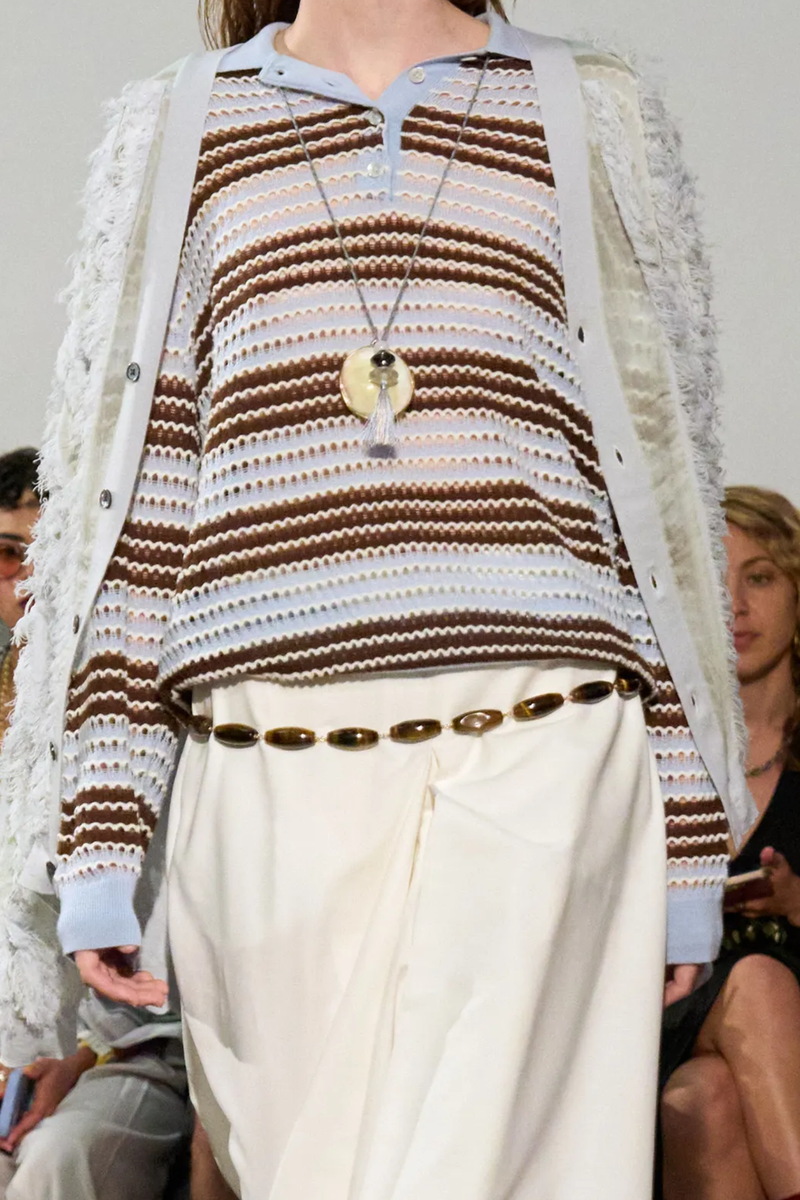 front profile model wearing Pointelle Stripe Polo blue brown stripe Fine-gauge merino wool
Open-work detailing
Point collar
Three button-placket
Long sleeves
Classic fit
Hem falls to the hip
Pullover style
Merino wool