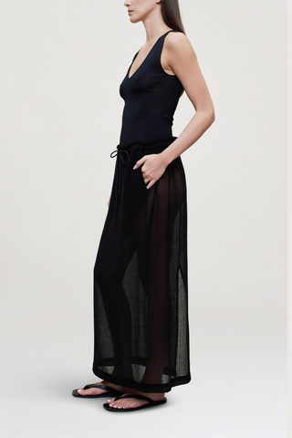 side profile model wearing  Portia V-Neck Compact Viscose Bodysuit black Sleeveless 
Close, smooth fit through the body
88% Viscose / 12% Polyamide