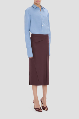 side profile model wearing  Pressed Tailored Flannel Skirt Acai (Merlot) Pressed Tailored Skirt
Compact flannel
Fabric is pressed for a sharp, structured finish
Fit & flare shape
Mid rise and midi length
Exposed seam detailing
100% Virgin Wool