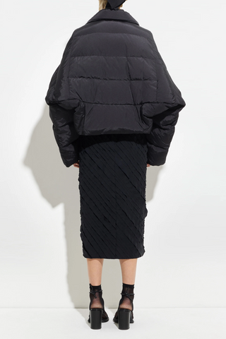 back profile model wearing Puffer Coat Black cropped fit Wide sleeves that taper gently at the cuff, elastic drawcord hem