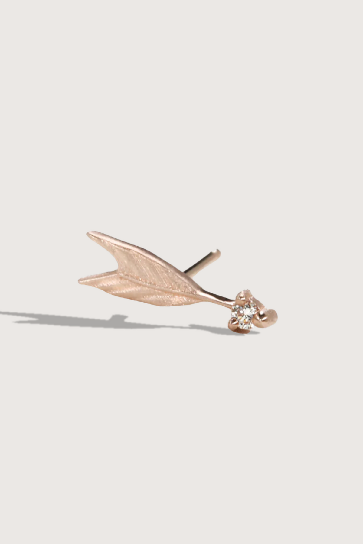 flat lay Quilted Arrow Stud earring 14k gold with diamond