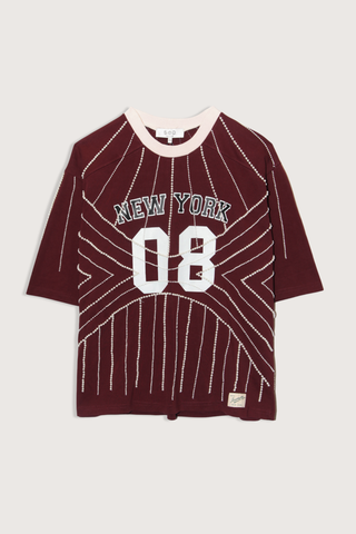 flat lay Quinn T-Shirt burgundy Beaded t-shirt
Inspiration from classic sports jerseys
Varsity-style lettering and numerals
Contrast trim at the collar
Intricate pearl beading throughout
Each piece is hand beaded
Slight variations in bead placement, spacing, and natural drape may occur
100% cotton
Relaxed fit