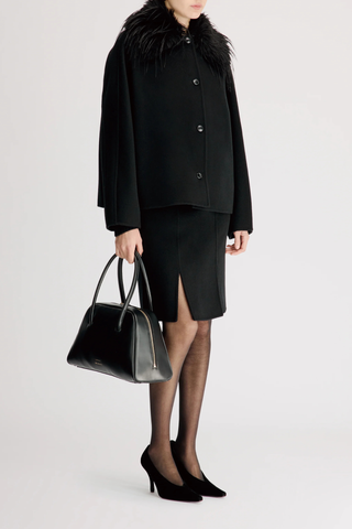 side profile model wearing Rafe Jacket With Removable Faux Collar black Heavy wool and cashmere drap
Softly rounded shape
Fluid contour that gracefully envelops the body
Removable faux fur collar
Front button closure
90% WV 10% WS