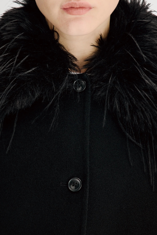 close up faux fur texture detail for Rafe Jacket With Removable Faux Collar black Heavy wool and cashmere drap
Softly rounded shape
Fluid contour that gracefully envelops the body
Removable faux fur collar
Front button closure
90% WV 10% WS