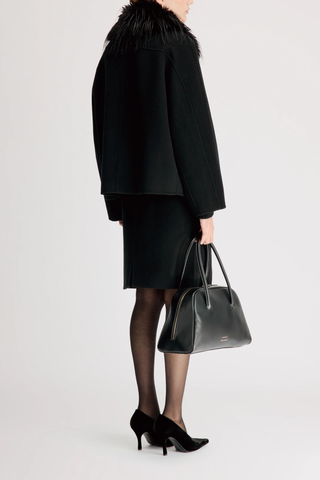 back profile model wearing Rafe Jacket With Removable Faux Collar black Heavy wool and cashmere drap
Softly rounded shape
Fluid contour that gracefully envelops the body
Removable faux fur collar
Front button closure
90% WV 10% WS
