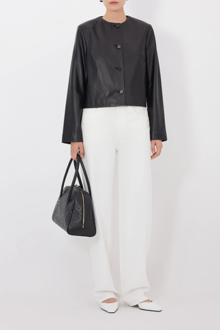 front profile model wearing Raho Leather Jacket Black Soft plongé lambskin leather
Slightly cropped
Boxy fit
Crew neck
Long sleeves
Four-button placket.