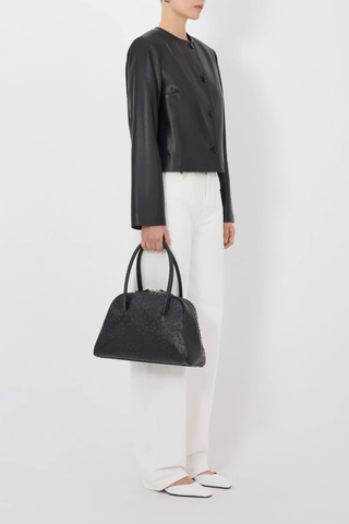 side profile model wearing Raho Leather Jacket Black Soft plongé lambskin leather
Slightly cropped
Boxy fit
Crew neck
Long sleeves
Four-button placket.