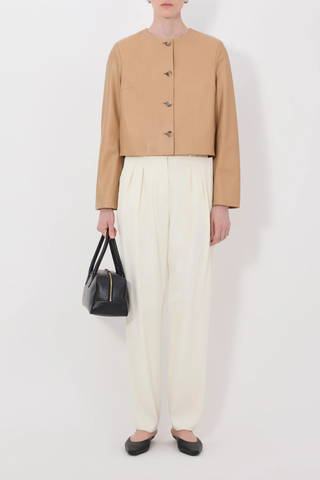 front profile model wearing Raho Leather Jacket Sienna Soft plongé lambskin leather
Slightly cropped
Boxy fit
Crew neck
Long sleeves
Four-button placket.