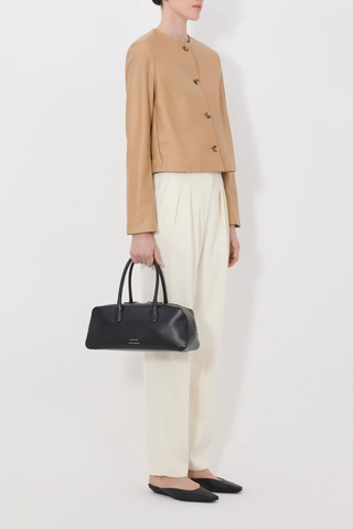 side profile model wearing Raho Leather Jacket Sienna Soft plongé lambskin leather
Slightly cropped
Boxy fit
Crew neck
Long sleeves
Four-button placket.