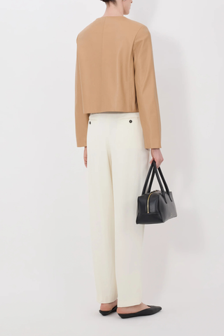 back profile model wearing Raho Leather Jacket Sienna Soft plongé lambskin leather
Slightly cropped
Boxy fit
Crew neck
Long sleeves
Four-button placket.