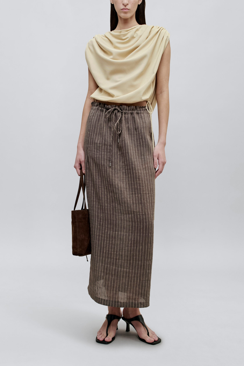 front profile model wearing Regina Stripe Skirt graphite traight cut
Drawstring waist
Elevated linen stripe
Adjustable
Midi length
High back slit
Side seam pockets
Hardware at drawstring
