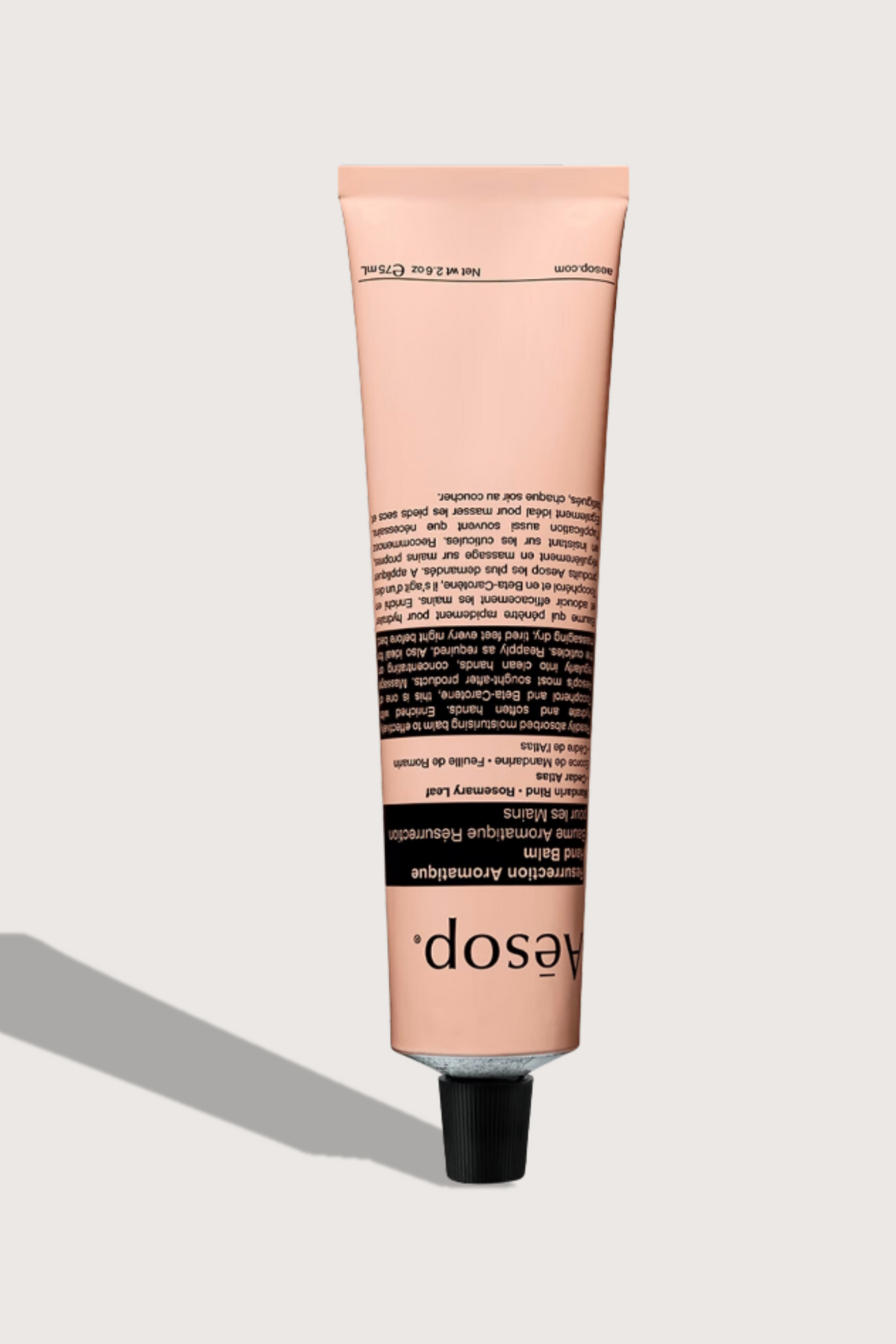 flat lay Resurrection Aromatique Hand Balm Tube pink tube with cap