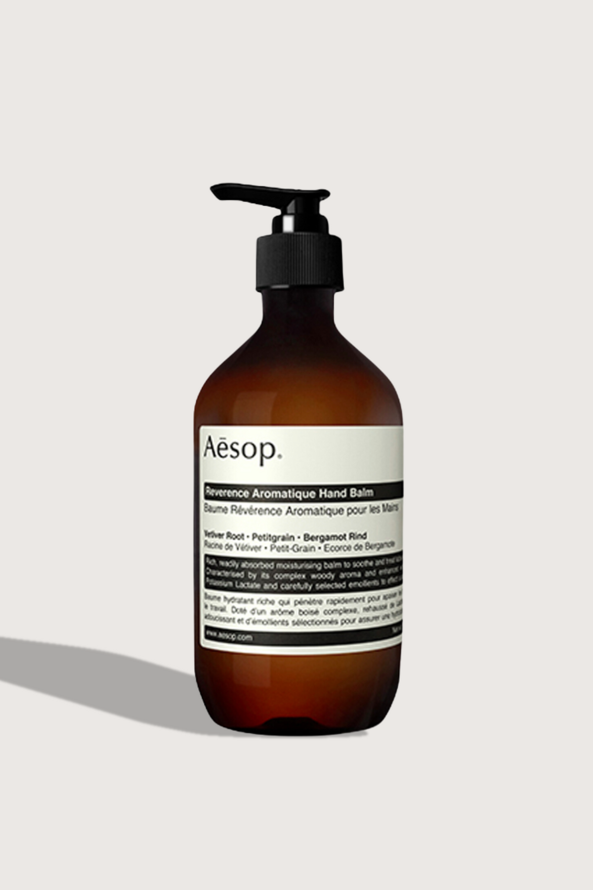 flat lay Reverence Hand Balm 500mL brown bottle with pump