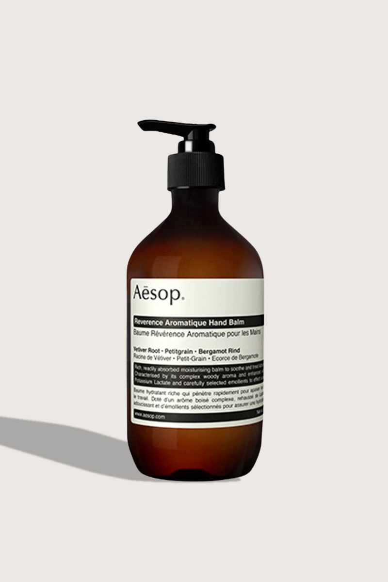 flat lay Reverence Hand Balm 500mL brown bottle with pump