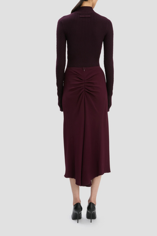 back profile model wearing Ribbed Long Sleeve with thumb holes Knit Polo Merlot high v-neckline merino wool curved v hemline