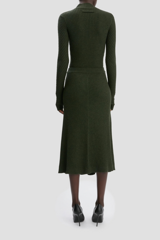 back profile model wearing Ribbed Long Sleeve with thumb holes Knit Polo Oregano high neck with v-neckline merino wool curved v hemline