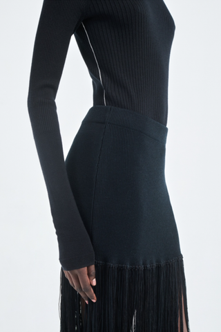 side profile model wearing  Ribbed Turtleneck Black slim fit long sleeve  with white line detail on the side