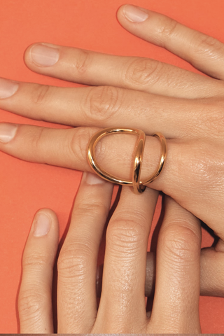 model wearing Ribbon Ring Vermeil 925 Silver covered with 18 carat gold (Vermeil 5 microns) Climbs and snakes, landing and curving around the finger in unconventional ways