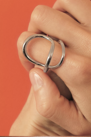 model wearing Ribbon Ring sterling Silver curving around the finger