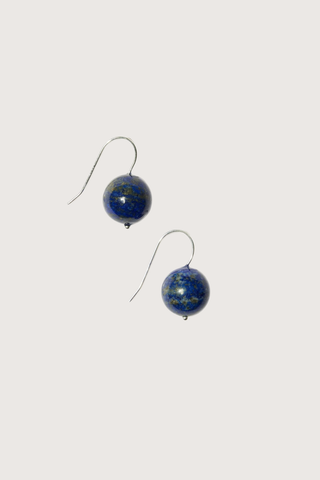 flat lay Rosette Drop Earrings Blue Lapis Blue lapis bead is suspended against a single sterling silver hoop
Crafted in sterling silver, with blue round lapis
Blue lapis diameter 12mm