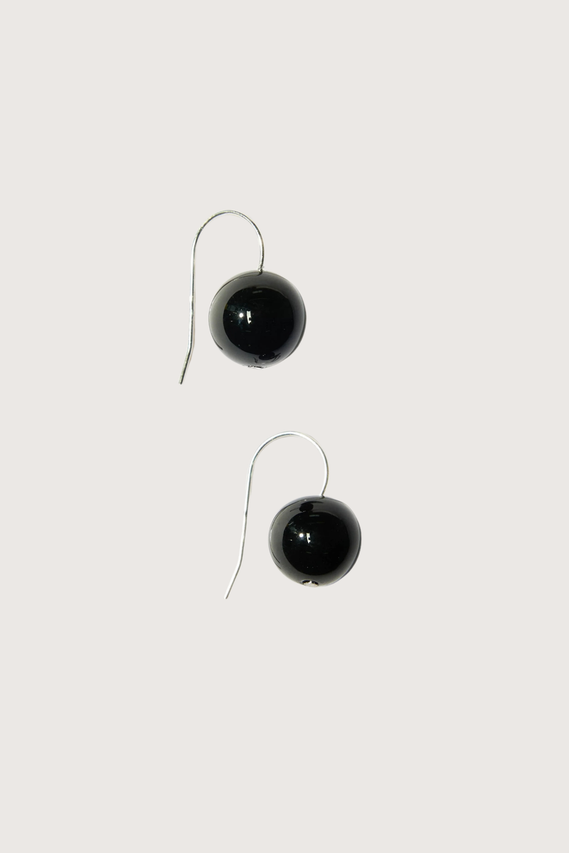 flat lay Rosette Drops Earrings Black Onyx Polished black onyx bead is suspended against a slender sterling silver hoop
Crafted in sterling silver, with round black onyx
Black onyx diameter 12mm