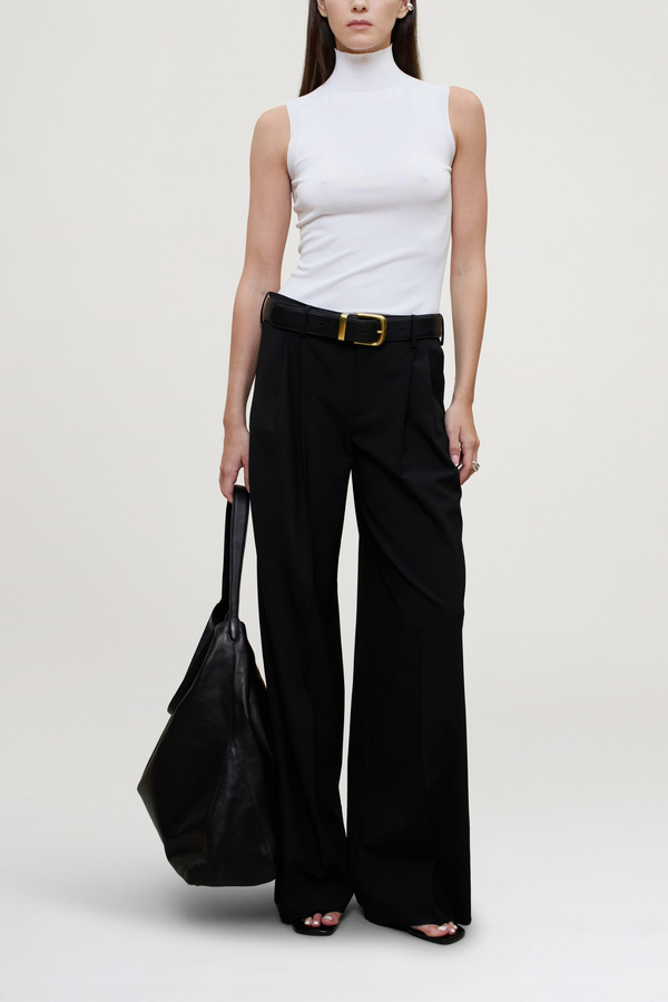 front profile model wearing Roxana Low Rise Tropical Wool Pant black wool
Pleated trouser
Relaxed yet refined fit
double-pleated front
Side seam pockets
Two buttoned back flap pockets
Wide looped waistband
Tab waist closure for a polished finish
Tropical wool