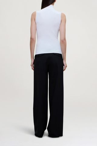 side profile model wearing Roxana Low Rise Tropical Wool Pant black wool
Pleated trouser
Relaxed yet refined fit
double-pleated front
Side seam pockets
Two buttoned back flap pockets
Wide looped waistband
Tab waist closure for a polished finish
Tropical wool