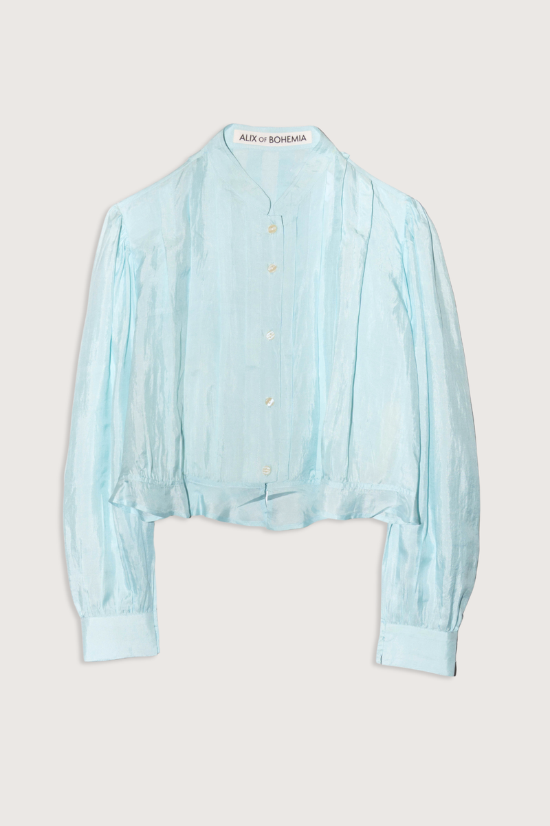 flat lay Ryland Morning Dew Silk Shirt light turquoise Victorian silhouette
Cropped shirt
Pleating details
button front
Ruffled hem
100% Silk