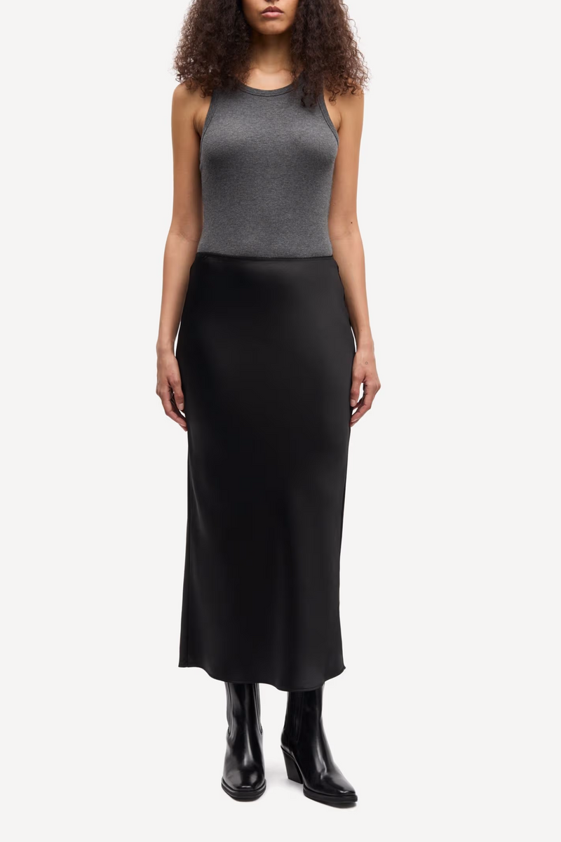 front profile model wearing Saagneta Long Satin Skirt Black slim fit elastic waist