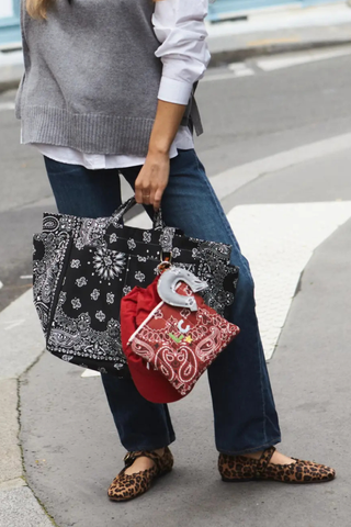 model wearing Sac Picnic Tote All Black cotton bandana two outside pockets two side pockets with short and tall handles