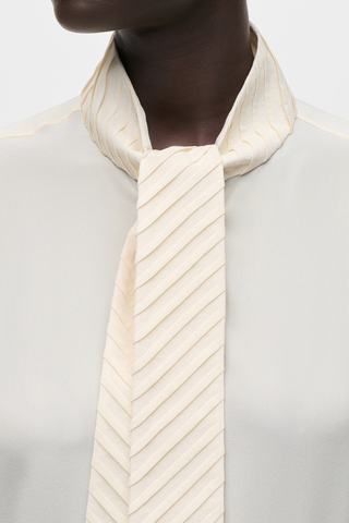 close up scarf detail for Scarf Detail Blouse ivory Washed crêpe de chine
Distinctive scarf detail at the neckline
Fluid drape
Tie neck and collar detail
Front button fastening
100% Silk