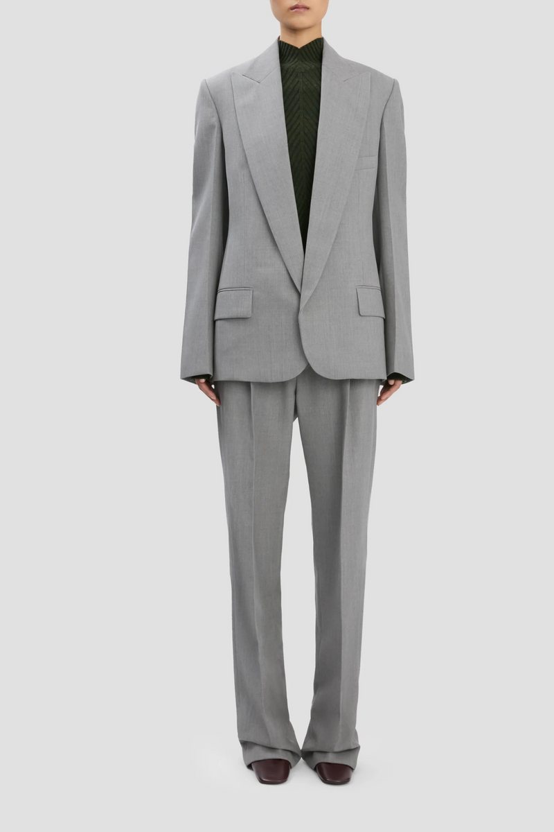 front profile model wearing Sculptural Sleeve Jacket light grey virgin wool oversized fit 3-hole button on cuff with contrast white stitch detail