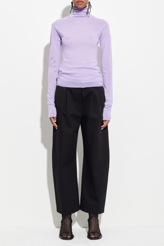 front profile model wearing Seamless Second Skin Turtleneck Top Orchid wool Classic roll-neck slim fit