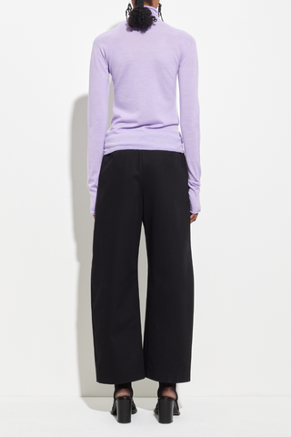 back profile model wearing Seamless Second Skin Turtleneck Top Orchid wool Classic roll-neck slim fit
