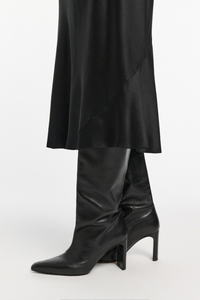 close up of hem cut for Sense Of Shine Skirt Black stretch silk midi length