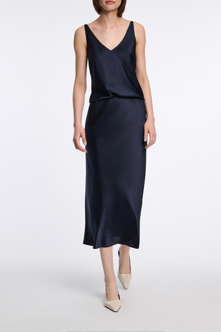 front profile model wearing Sense Of Shine Skirt Navy silk satin midi length